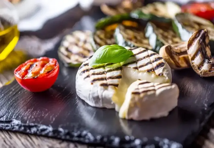 Pyszny camembert z grilla, z rumianymi paskami, podany z grillowanymi warzywami i pomidorkiem. Idealna przekąska na lato.